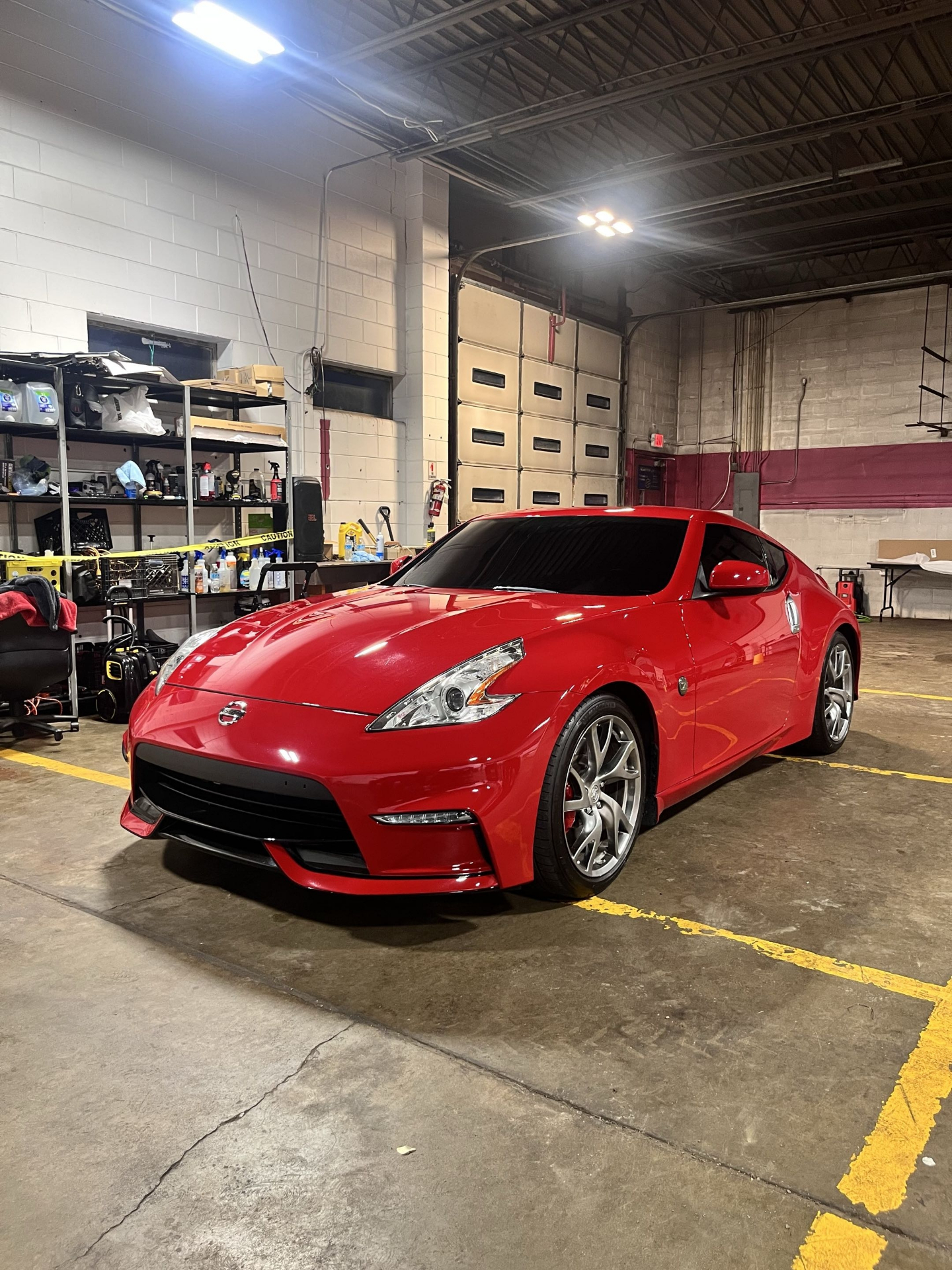 Red Nissan 370Z coupe with dark ceramic window tint